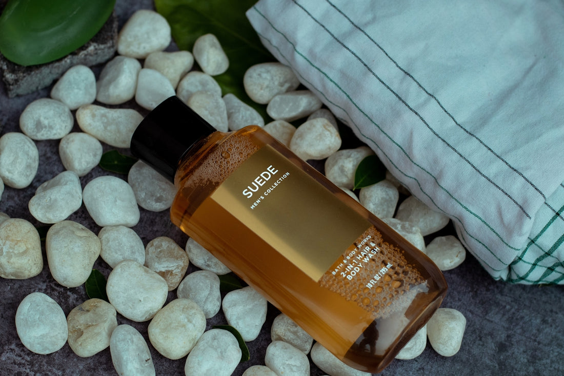 a bottle of shampoo sitting on top of a pile of rocks