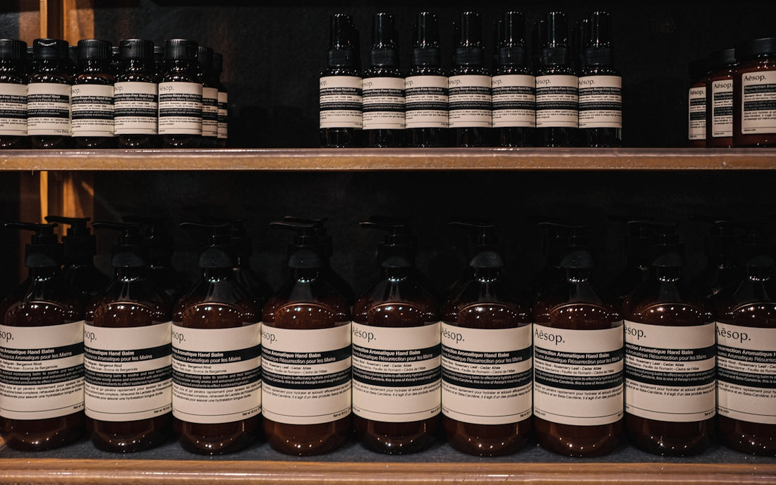 a shelf filled with lots of bottles of liquid