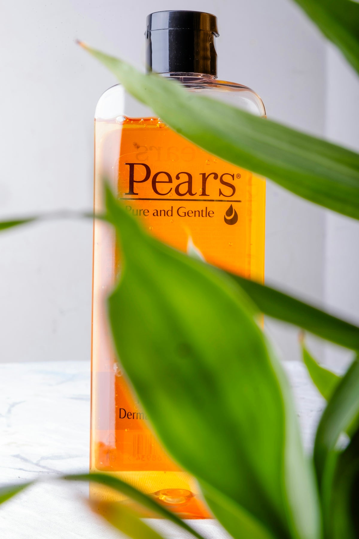 a close up of a bottle of soap on a table